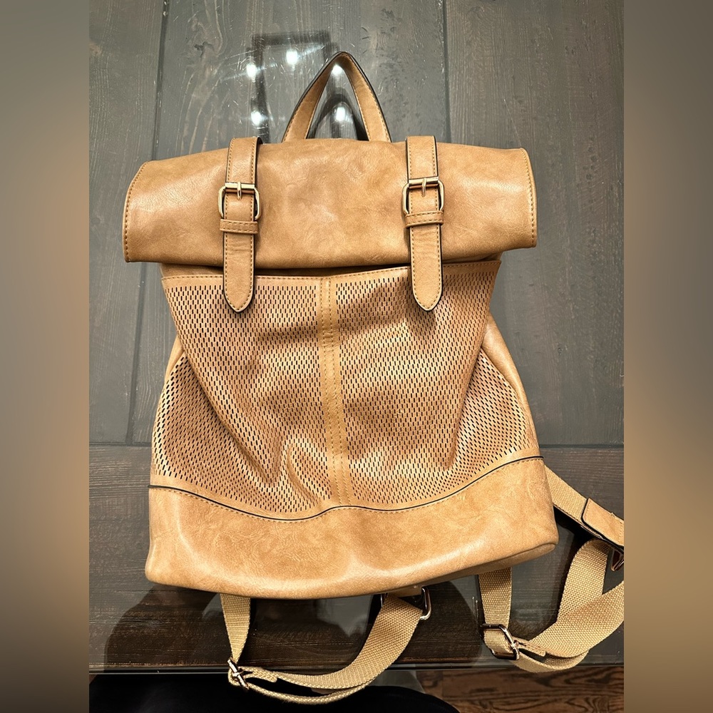Camel faux leather bag. Has adjustable backpack straps